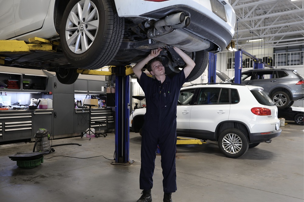 A young male operating a car.